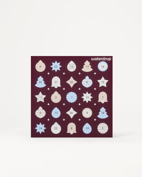 Calendar de Advent cu 24 de uși numerotate într-un pătrat mov închis pe un fundal deschis.