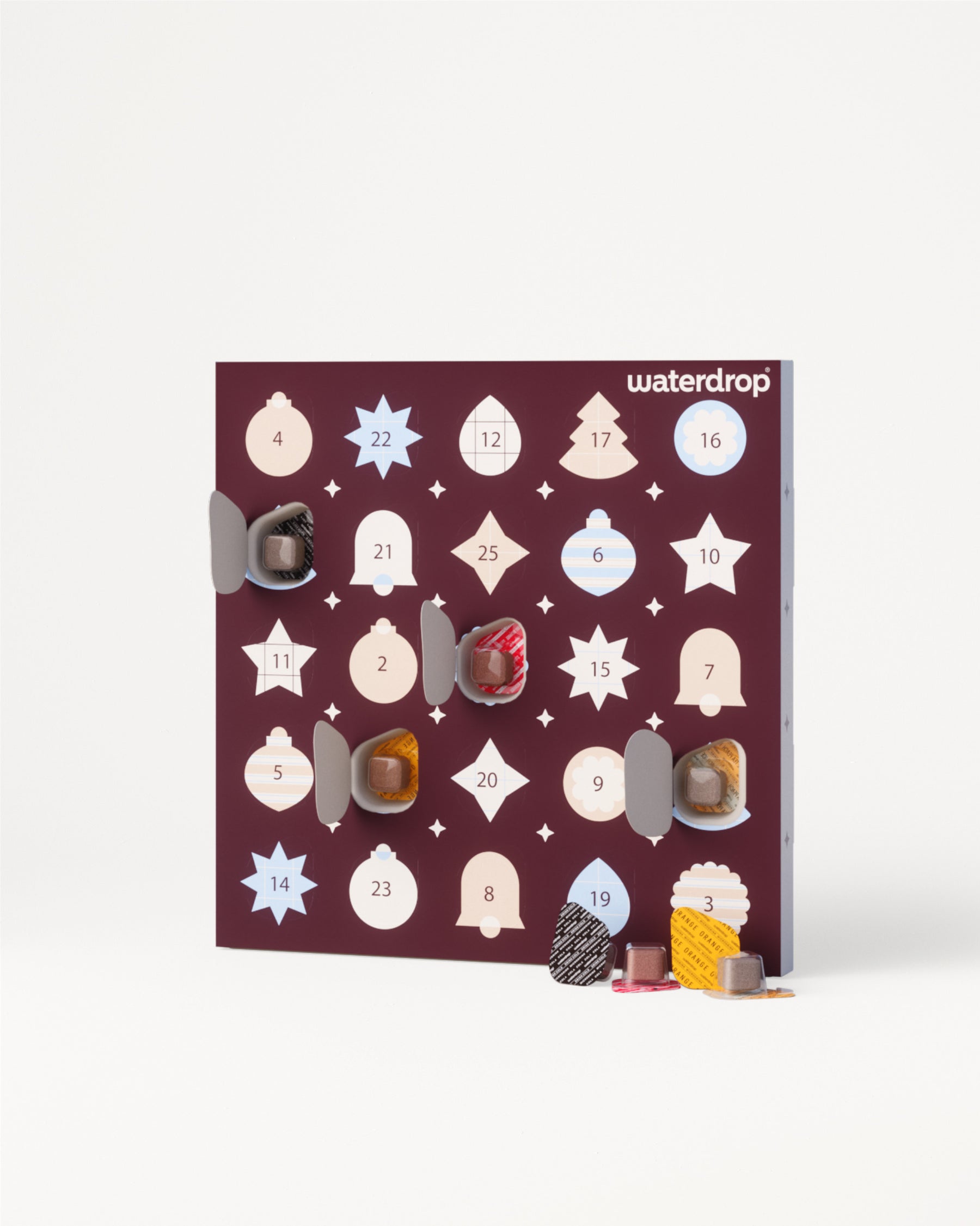 Calendar de Advent cu uși numerotate și ciocolate diverse.